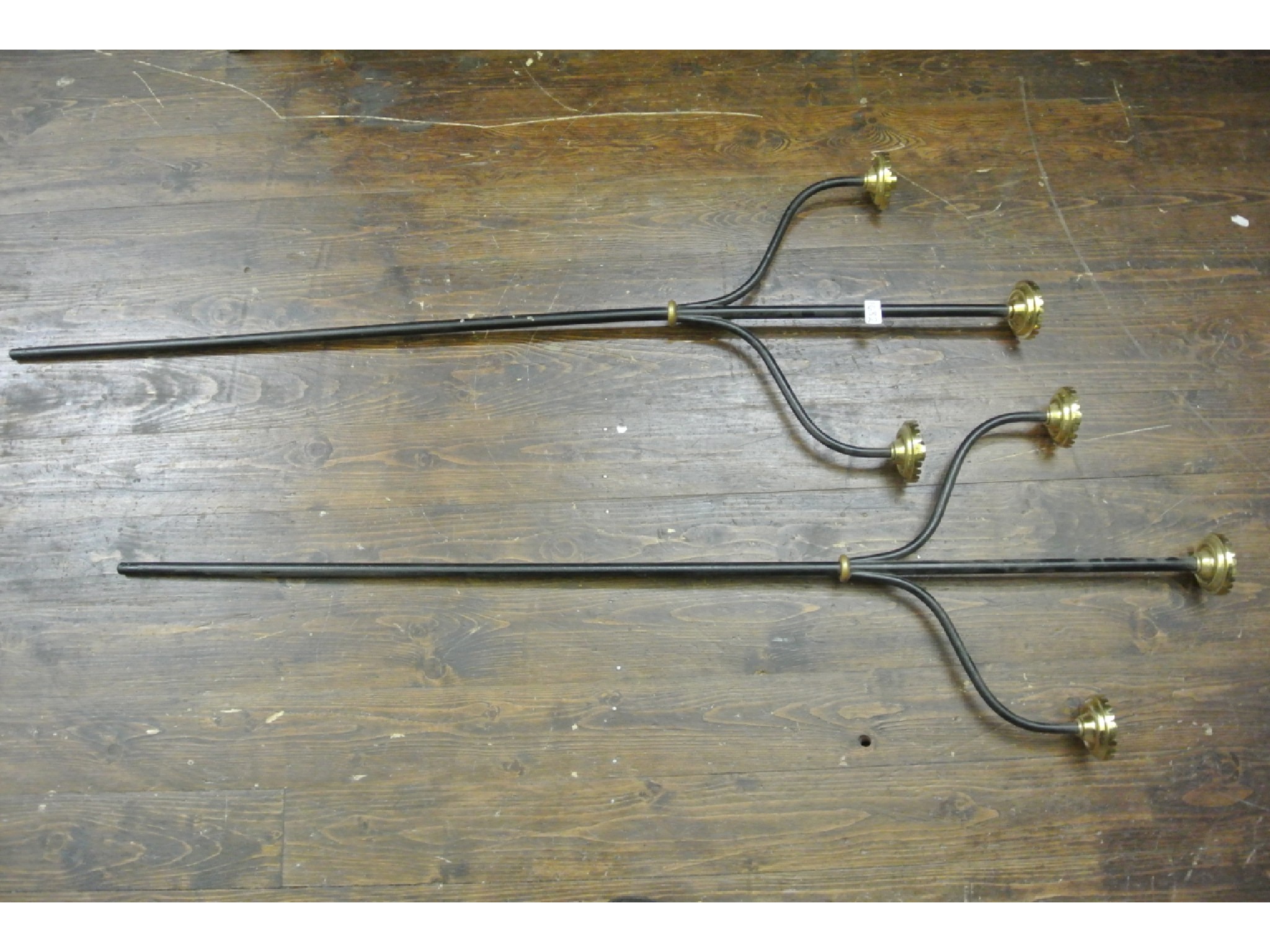 Appraisal: A pair of ecclesiastical three branch candelabra with brass sockets