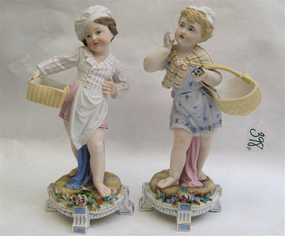 Appraisal: PAIR GERMAN BISQUE FIGURES barefoot young girls carrying baskets one