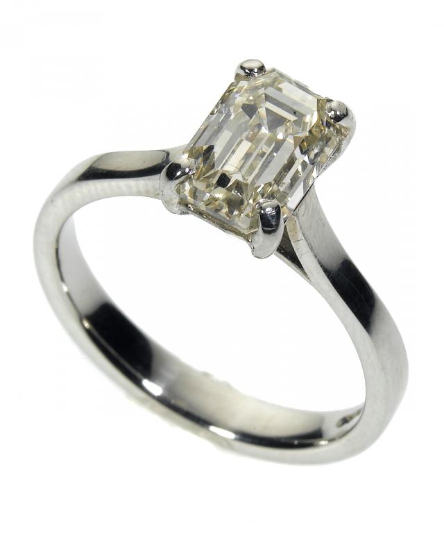 Appraisal: A DIAMOND SOLITAIRE RING the emerald cut diamond weighing approximately