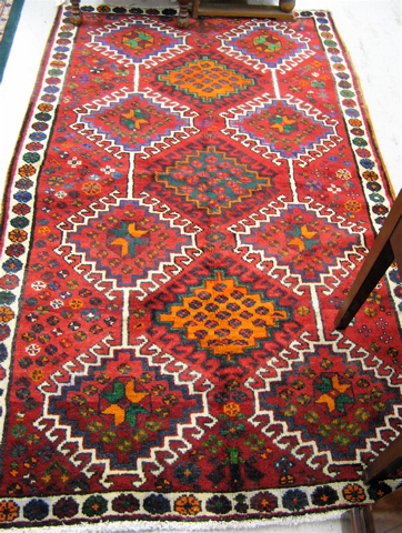 Appraisal: PERSIAN TRIBAL AREA RUG repeating geometric design on red ground