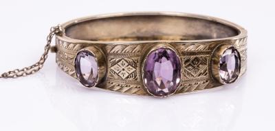 Appraisal: A silver gilt and amethyst hinged bangle the three oval