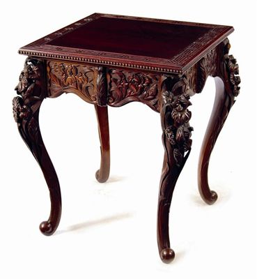 Appraisal: An oriental style carved and stained wood centre table the