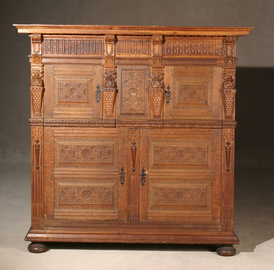 Appraisal: Pilgrim Century Style Carved Oak Two-Part Press Cupboard th- th