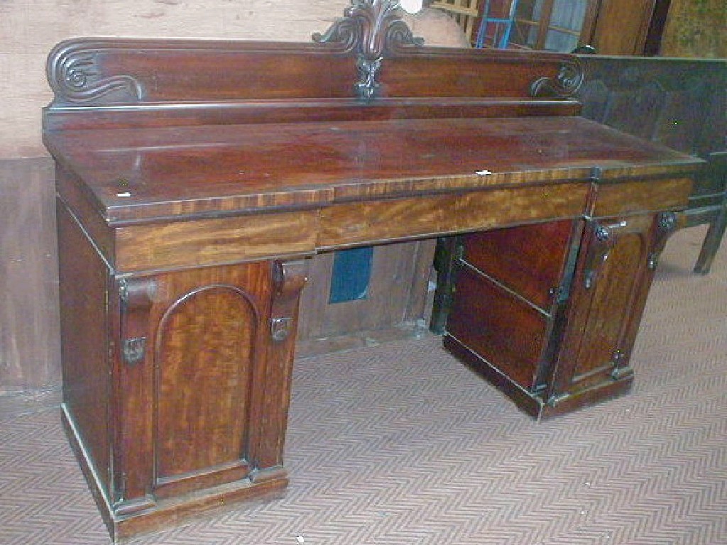 Appraisal: An early Victorian mahogany twin pedestal sideboard with carved back