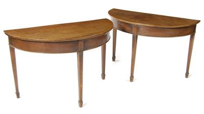 Appraisal: A pair of mahogany demi-lune side tables with plain friezes