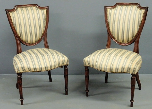 Appraisal: Pair of Sheraton style mahogany shield-back side chairs with striped