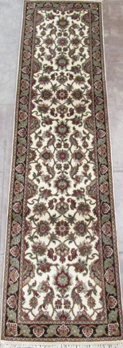 Appraisal: HAND KNOTTED ORIENTAL HALL RUG Indo-Persian featuring a colorful floral