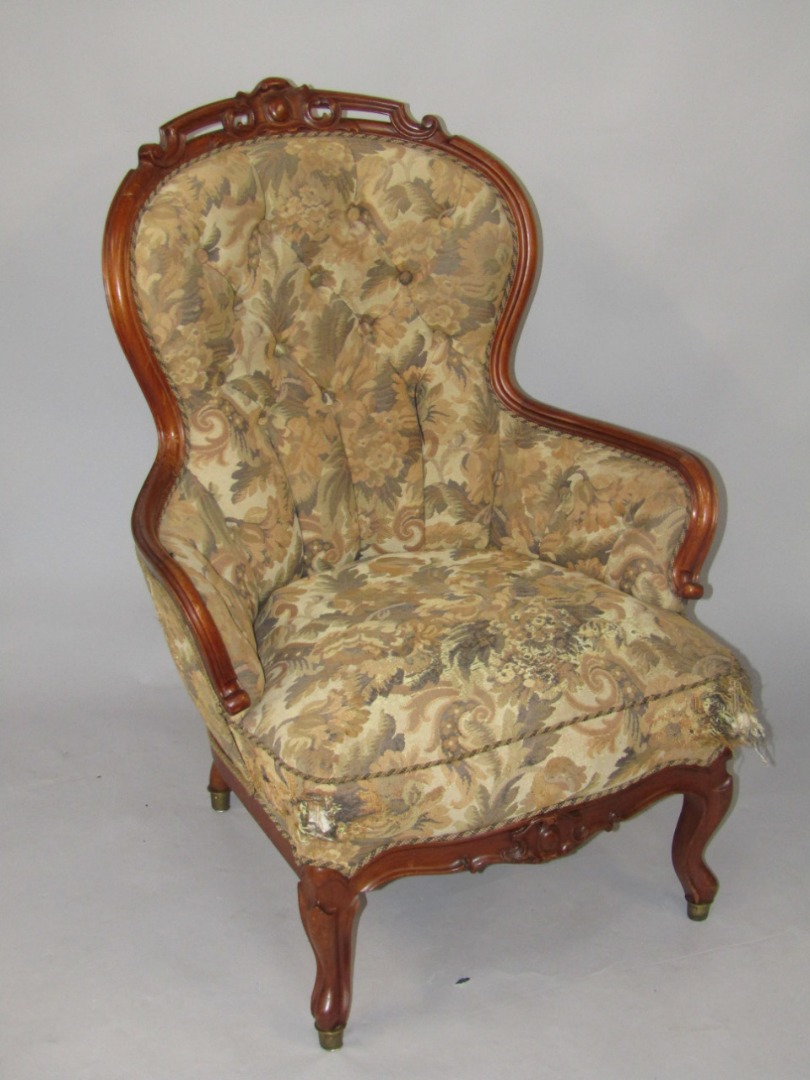 Appraisal: A Victorian mahogany balloon back armchair with carved crest rail