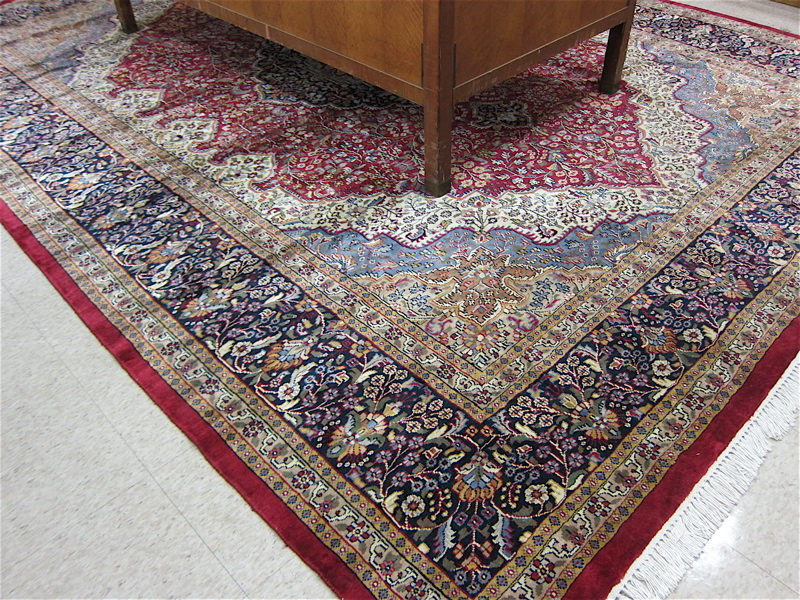 Appraisal: HAND KNOTTED ORIENTAL CARPET Indo-Persian floral and central floral medallion