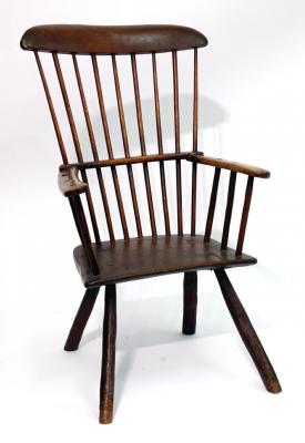 Appraisal: A WEST COUNTRY PRIMITIVE WINDSOR ARMCHAIR of comb back form