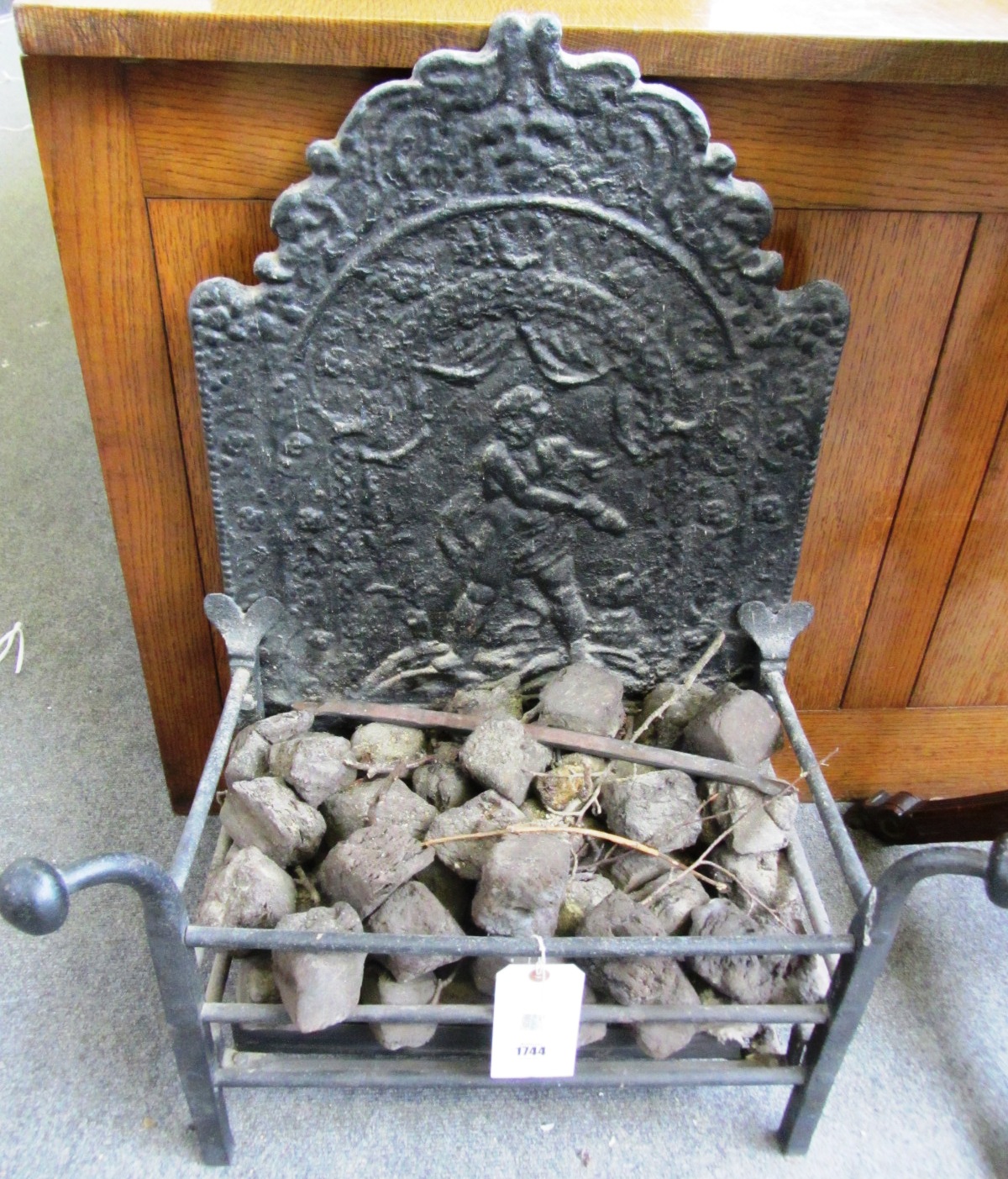 Appraisal: A th century style fire basket with integral relief moulded