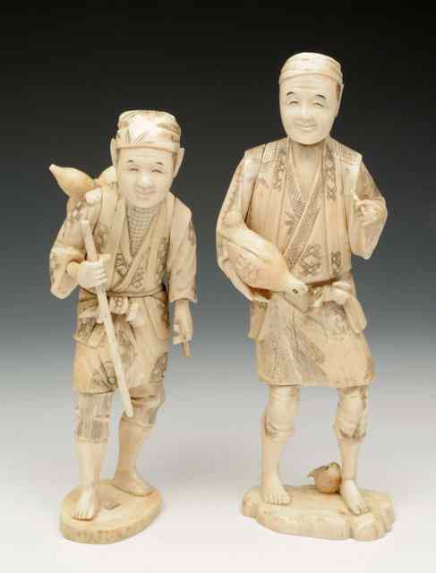 Appraisal: TWO STANDING JAPANESE CARVED IVORY FIGURES one holding chickens the