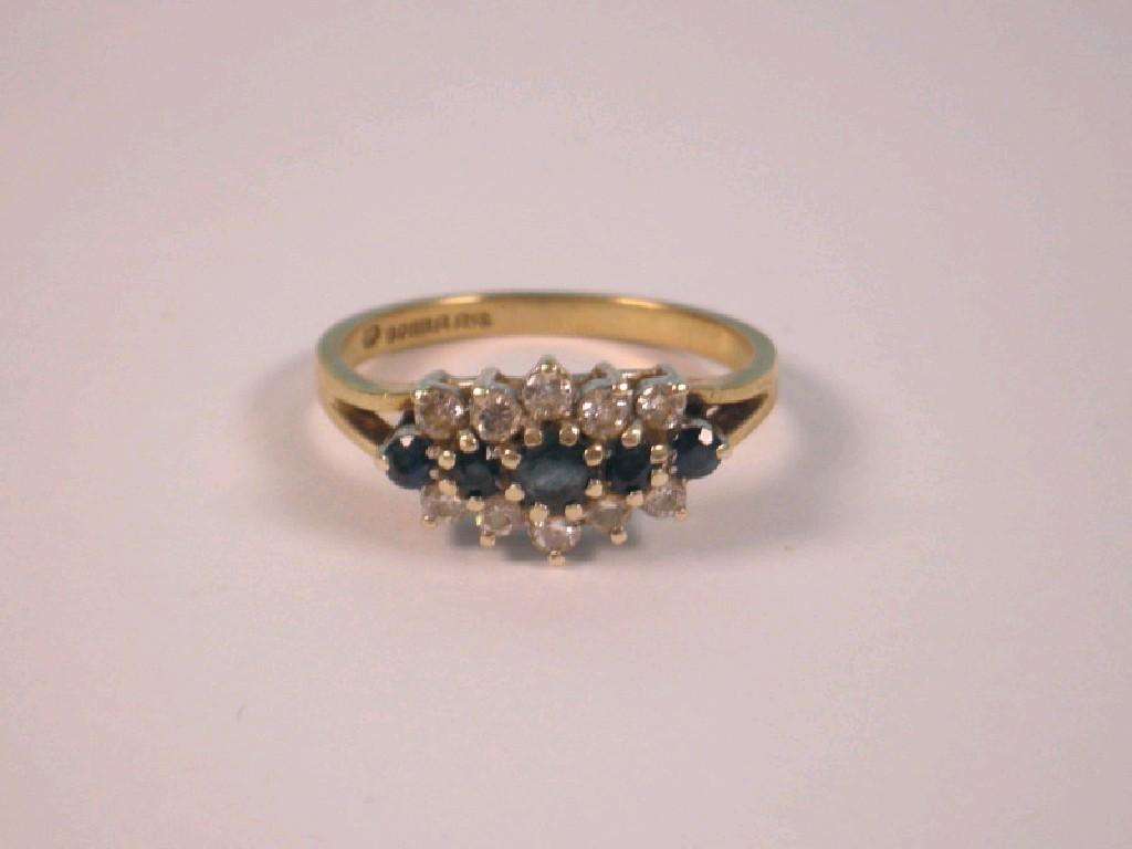 Appraisal: A sapphire and diamond cluster ring three bands of stones