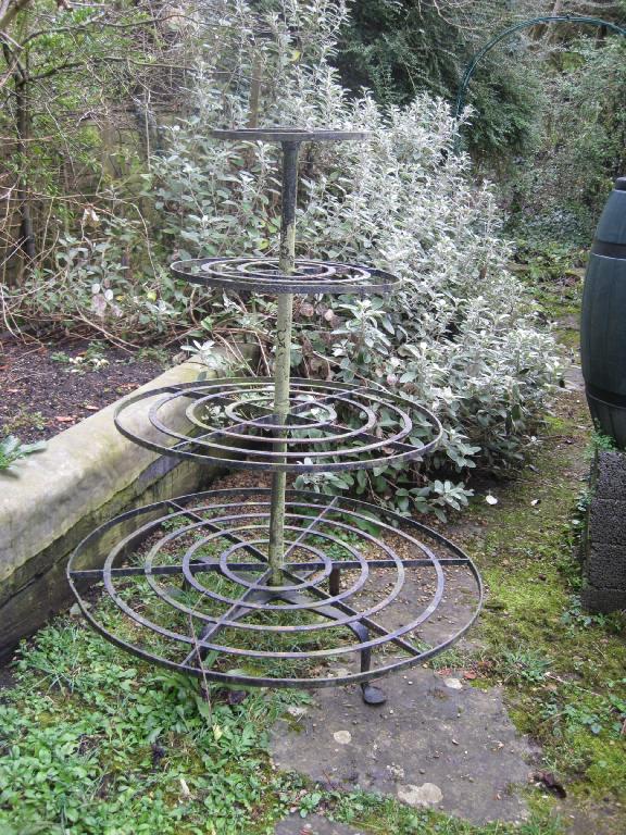 Appraisal: A four tier circular graduated iron Plantstand on quadruple splay