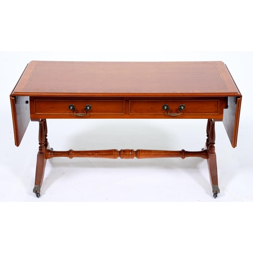 Appraisal: A yew wood and crossbanded sofa table in Regency style