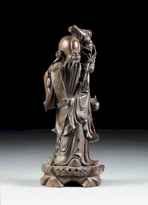 Appraisal: A CHINESE CARVED HARDWOOD FIGURE OF A SAGE IMMORTAL TH