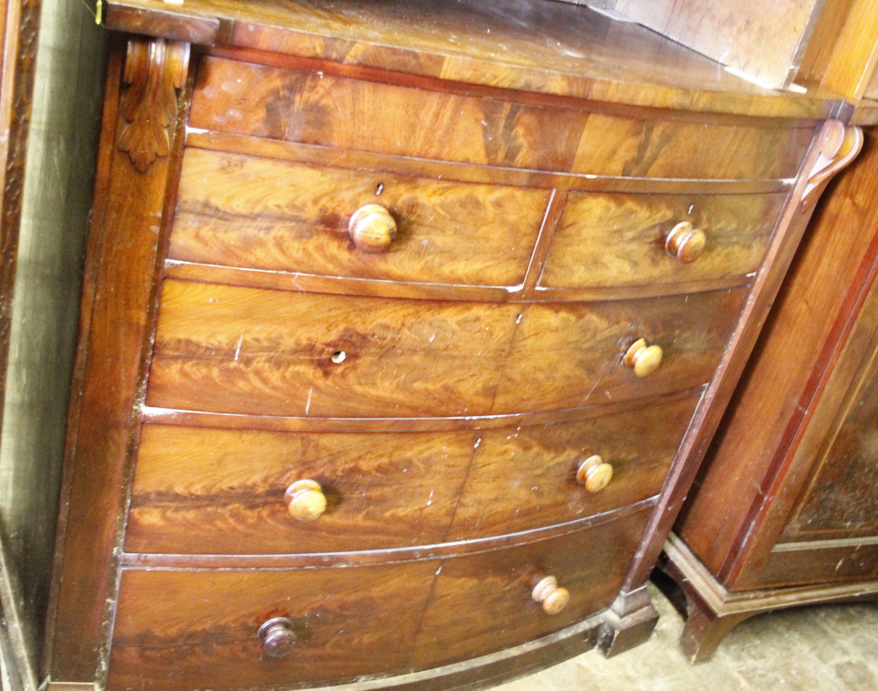 Appraisal: A thC flame mahogany veneered bow front chest of two