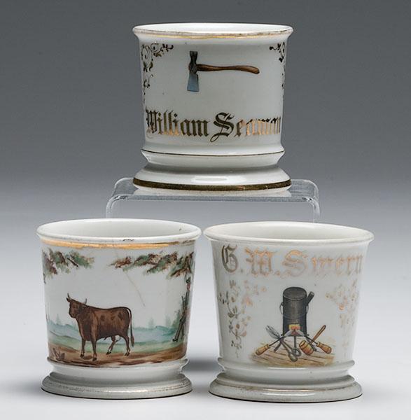 Appraisal: THREE OCCUPATIONAL SHAVING MUGS WOODSMAN TINSMITH AND GENTLEMAN FARMER Lot