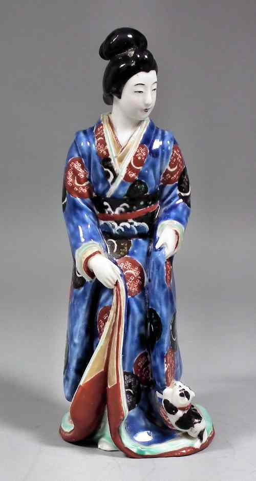 Appraisal: A Japanese porcelain figure - Geisha girl with dog painted