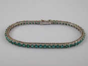 Appraisal: A white metal tests carat gold emerald line bracelet the