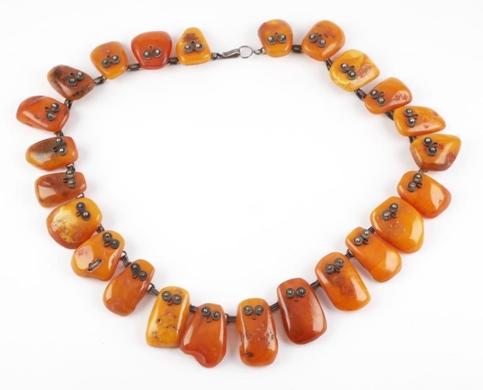 Appraisal: Rounded large amber stone necklace with silver detailed wire chain