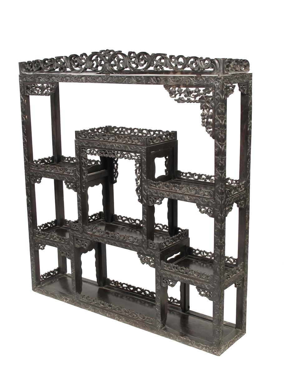 Appraisal: A th century Chinese carved and pierced ebony open display