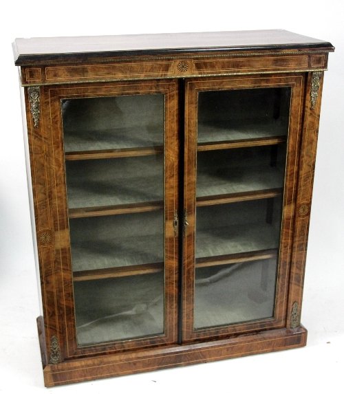 Appraisal: A Victorian walnut veneered bookcase with fan inlaid frieze above