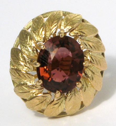 Appraisal: GRAPE TOURMALINE AND FOURTEEN KARAT GOLD RING centering an oval-cut