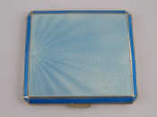 Appraisal: An enamelled silver compact the blue enamel over raying engine