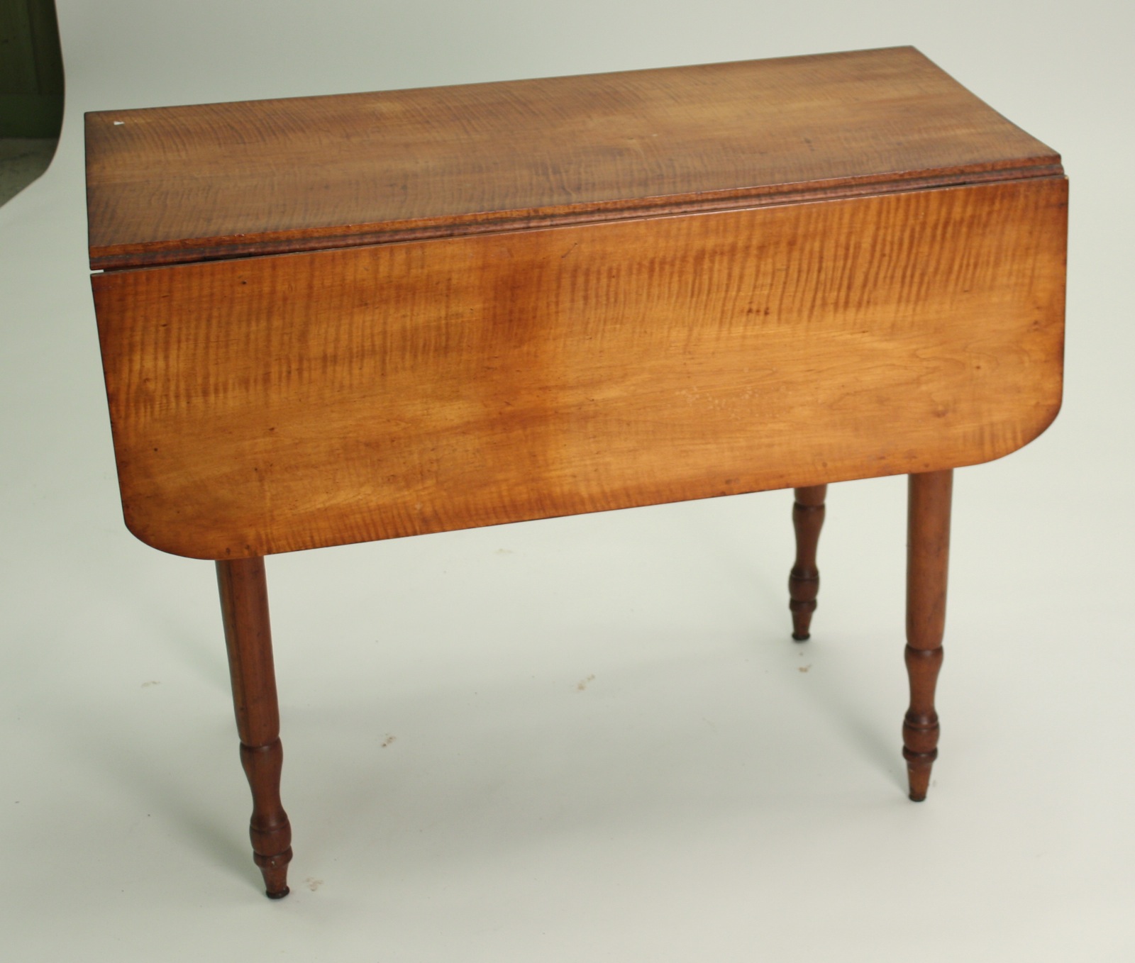 Appraisal: DROP-LEAF TABLE American th CenturyIn tiger maple Turned legs Height