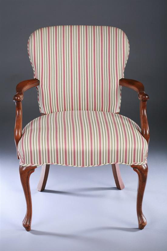 Appraisal: CONTINENTAL CARVED WALNUT ARM CHAIR th century with striped red