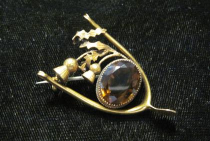 Appraisal: karat yellow gold and citrine 'wishbone' broochOval cut citrine bezel