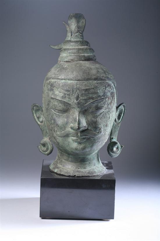 Appraisal: INDIAN BRONZE HEAD OF BUDDHA AND NAGA Wearing a moustache