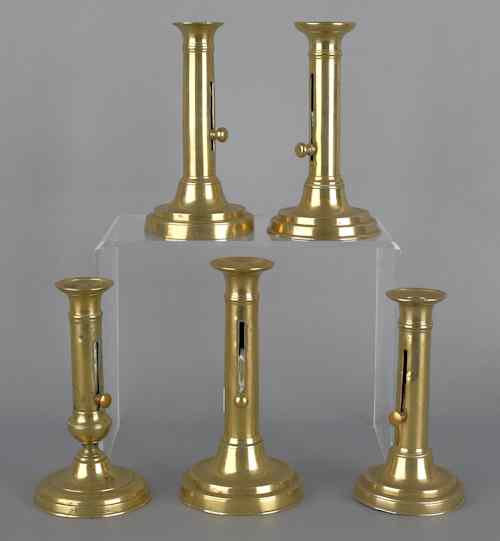 Appraisal: Five brass slide ejector candlesticks th c