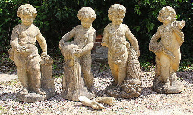 Appraisal: A SET OF FOUR CAST COMPOSITE STATUES of Putti each