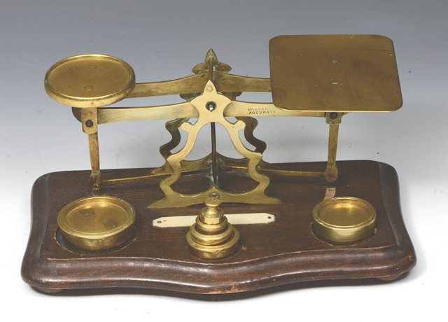 Appraisal: A SET OF BRASS LETTER SCALES with graduated weights