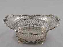 Appraisal: A small pierced silver basket with applied mask and scroll