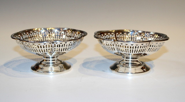 Appraisal: A PAIR OF SILVER PIERCED SWEET MEAT DISHES of flower