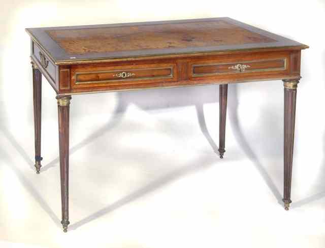 Appraisal: A FRENCH STYLE MAHOGANY AND BRASS WRITING TABLE with leather