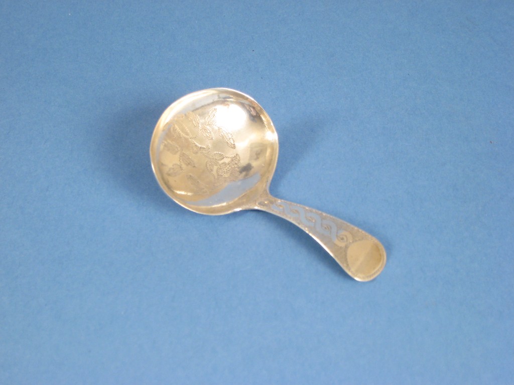 Appraisal: A George III Caddy Spoon with finely floral engraved oval