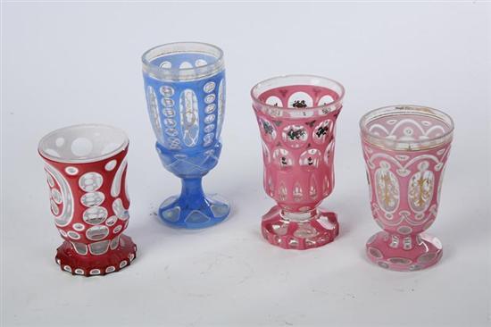 Appraisal: FOUR CUT OVERLAY FOOTED SPILLS American mid th century glass