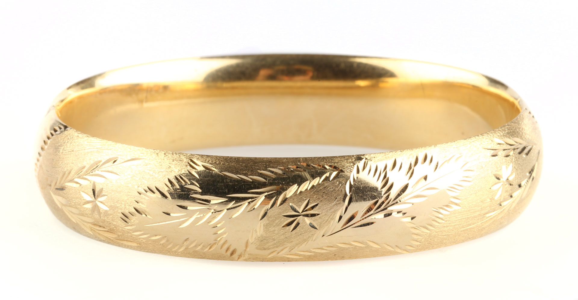 Appraisal: An Engraved Bangle Bracelet K leaf motif engraved bracelet approximately