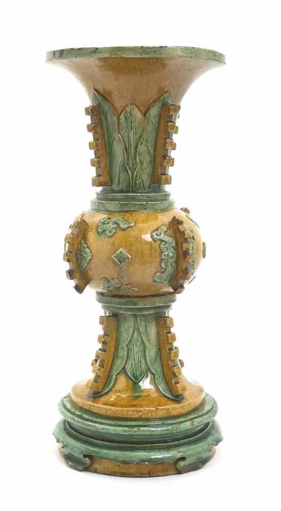 Appraisal: A Sancai Glazed Gu Form Vessel having stiff plantain leaf