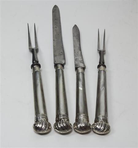 Appraisal: A mother of pearl handled carving set with indistinct Sheffield