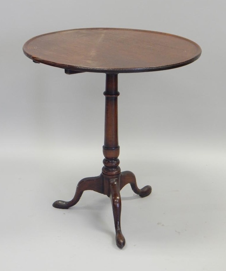 Appraisal: A thC oak occasional table the circular dished top on