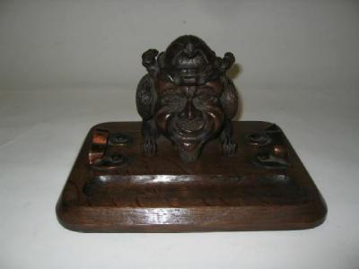 Appraisal: A VICTORIAN OAK INKWELL carved as a gargoyle the hinged