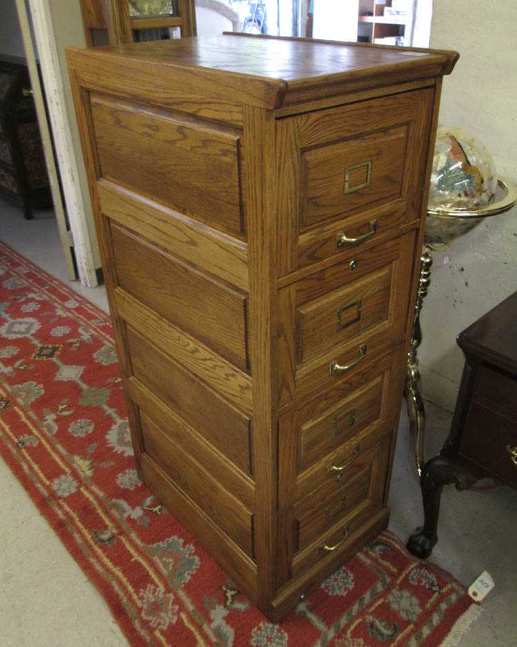 Appraisal: FOUR-DRAWER OAK FILE CABINET American antique reproduction featuring a column