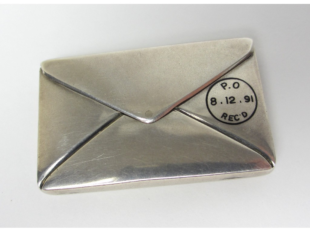 Appraisal: A Victorian silver stamp case modelled as a stamped letter