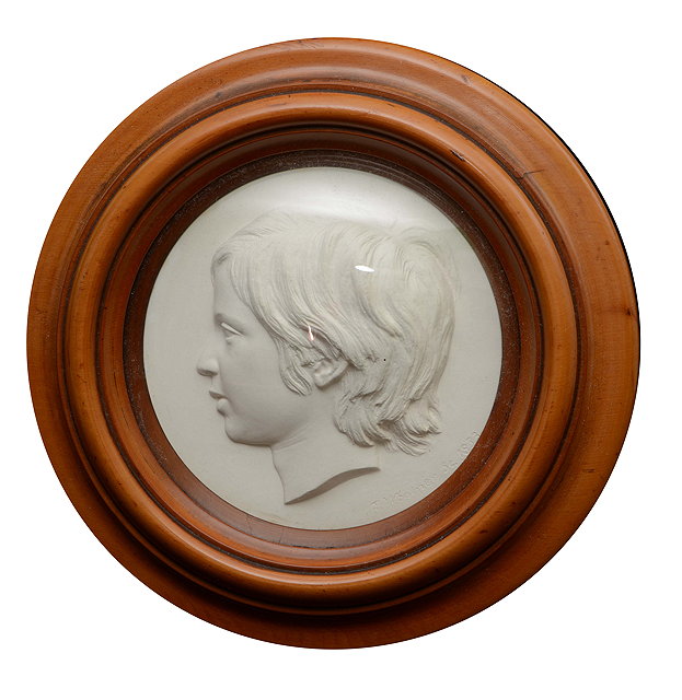 Appraisal: T WOOLNER - A Victorian circular plaster profile relief portrait