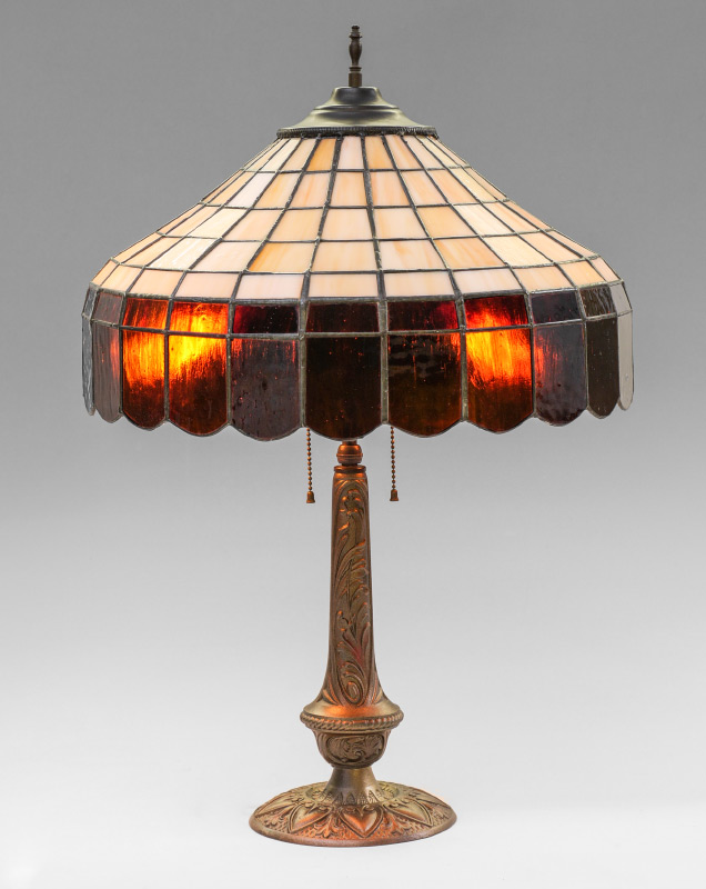 Appraisal: LEADED SLAG GLASS TABLE LAMP Unmarked patinated cast metal base